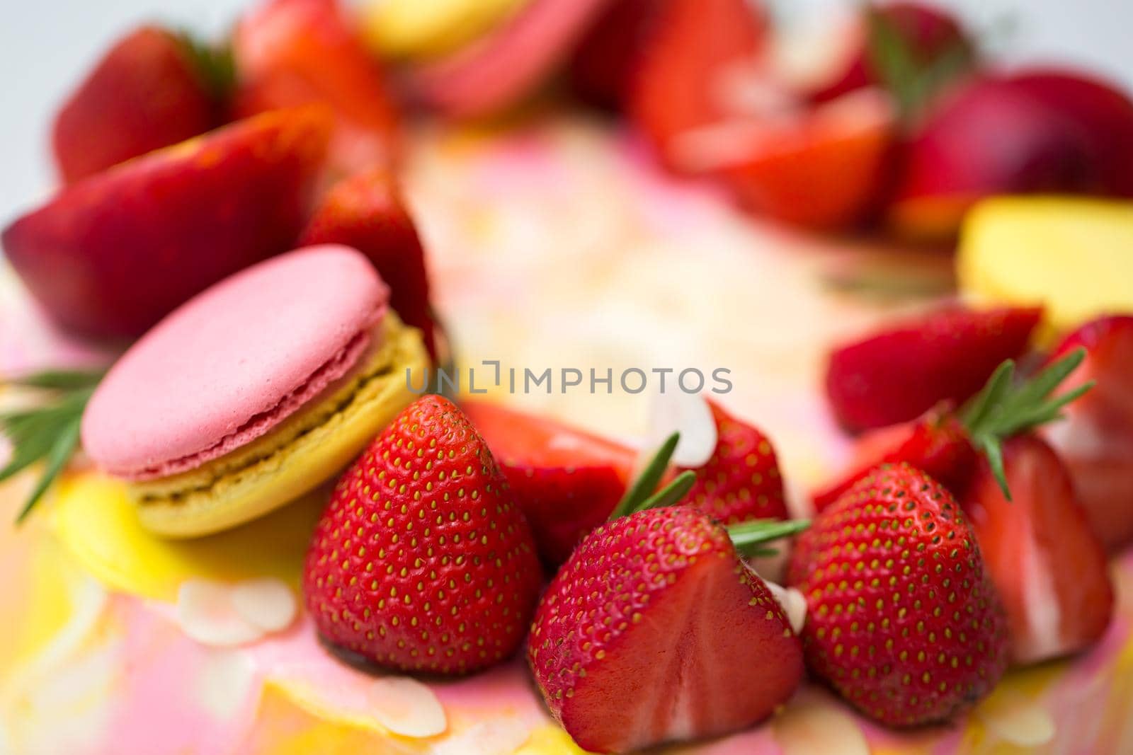 Cake yellow and pink splotches, strawberries, peaches, macaroons rosemary