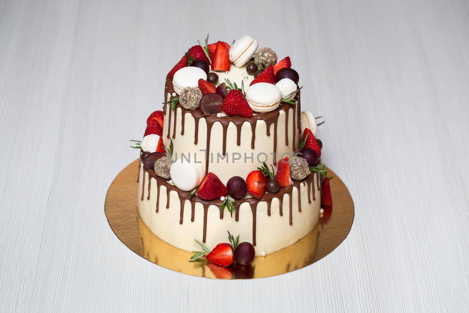 A bright cake with strawberries and chocolate streaks.