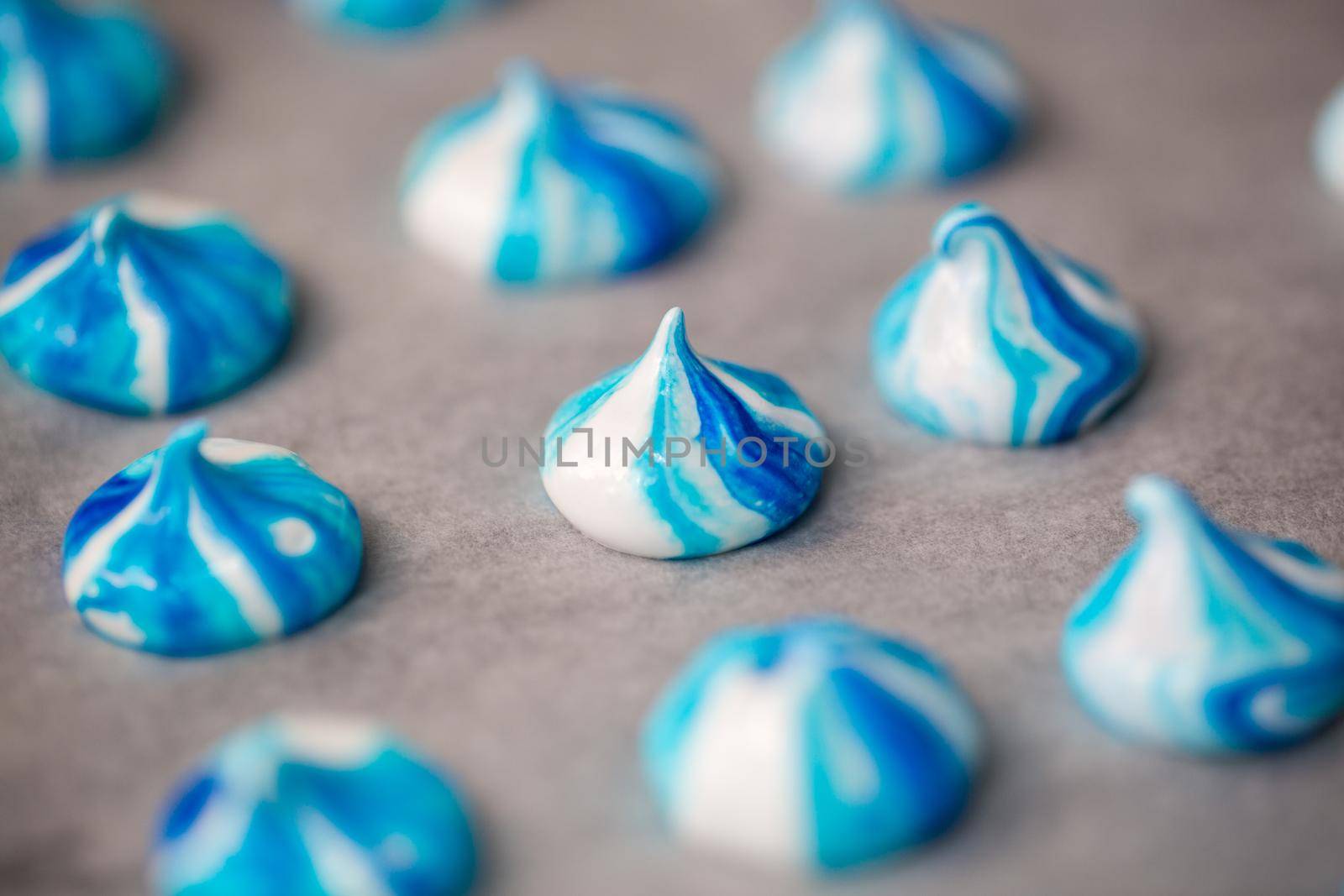 Meringue is a white and blue dessert on parchment by StudioPeace