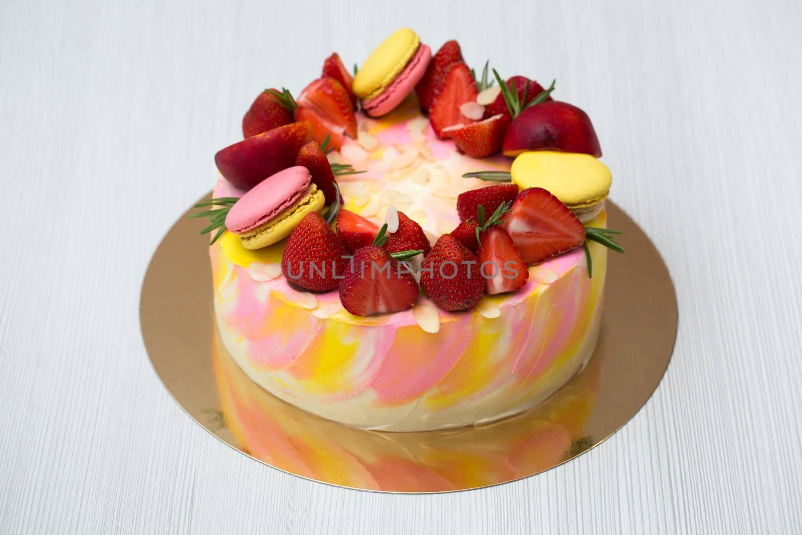 Cake yellow and pink splotches, strawberries, peaches, macaroons, rosemary. by StudioPeace