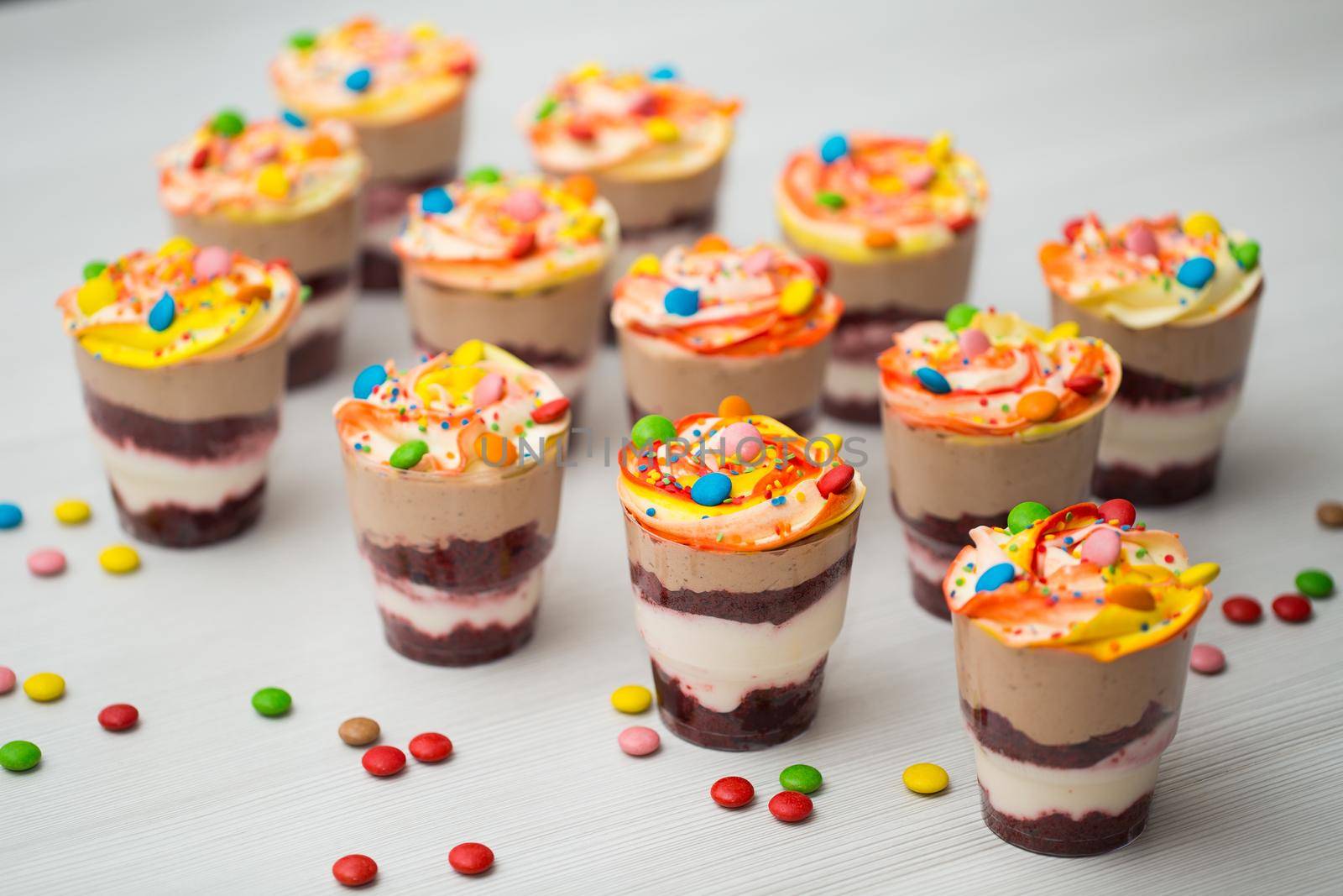 Chocolate and mousse trifle dessert in plastic cups.