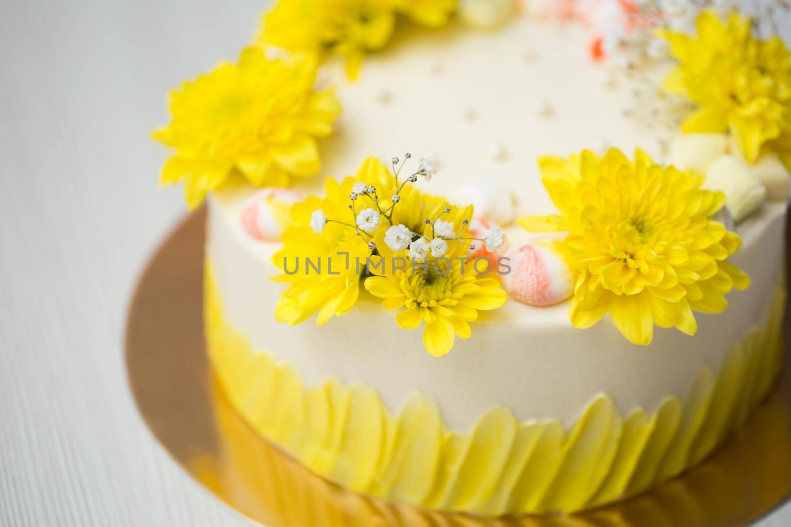 Cake with yellow stains, yellow chrysanthemums and meringue. by StudioPeace