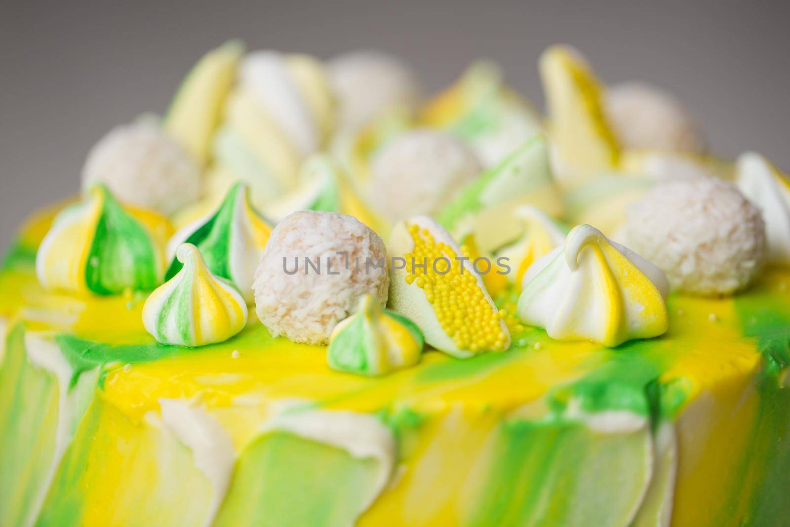 Cake watercolor painting of yellow and green color with a meringue, sweets and marshmallows. by StudioPeace