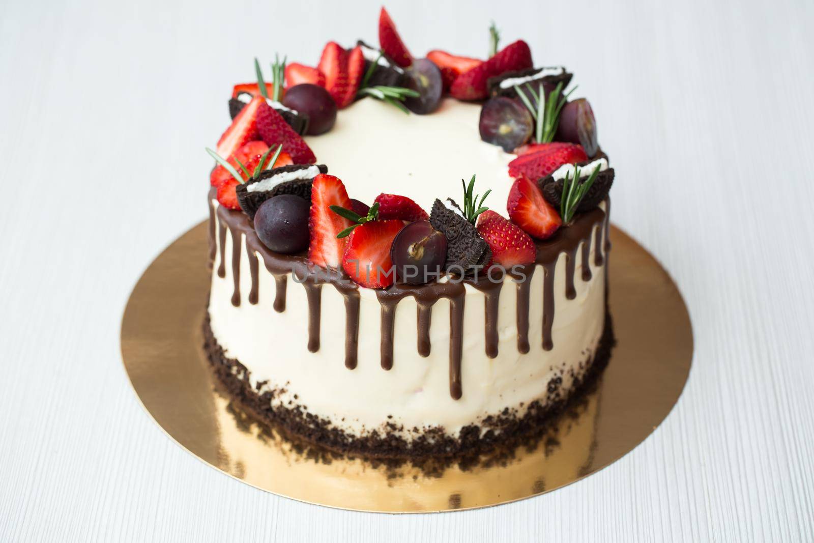 Cake with chocolate stains, strawberries, grapes, rosemary by StudioPeace