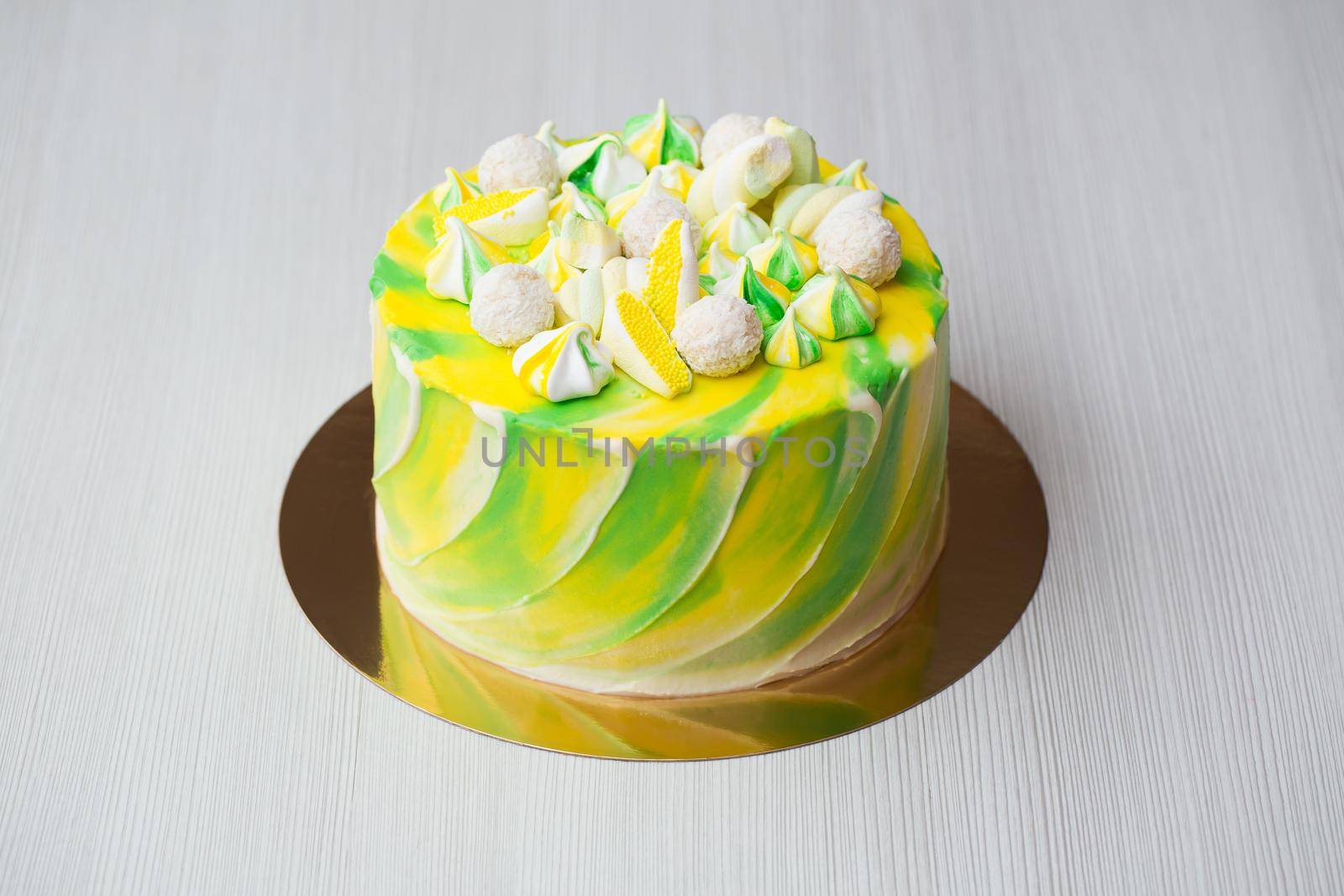 Cake watercolor painting of yellow and green color with a meringue, sweets and marshmallows. by StudioPeace