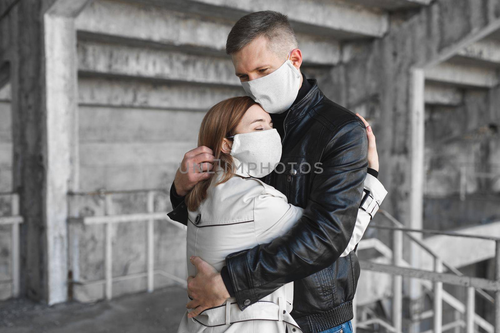 Masked man and woman embrace. Coronavirus. Covid19.