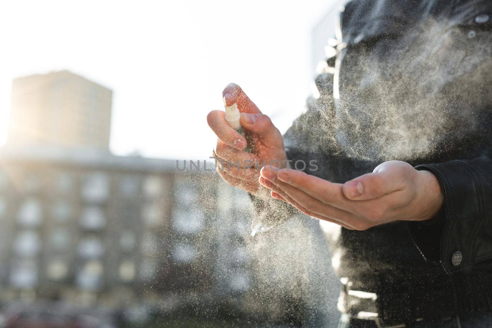 Disinfection of the hands. A person using an antiseptic spray on their hands to prevent a coronavirus or flu disease. Personal hygiene. Coronavirus. Covid 19.