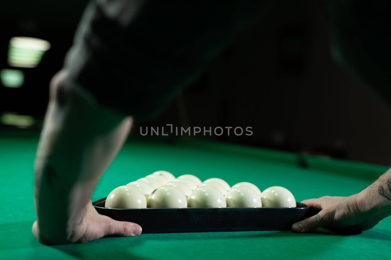Placing balls at the billiard table with triangle