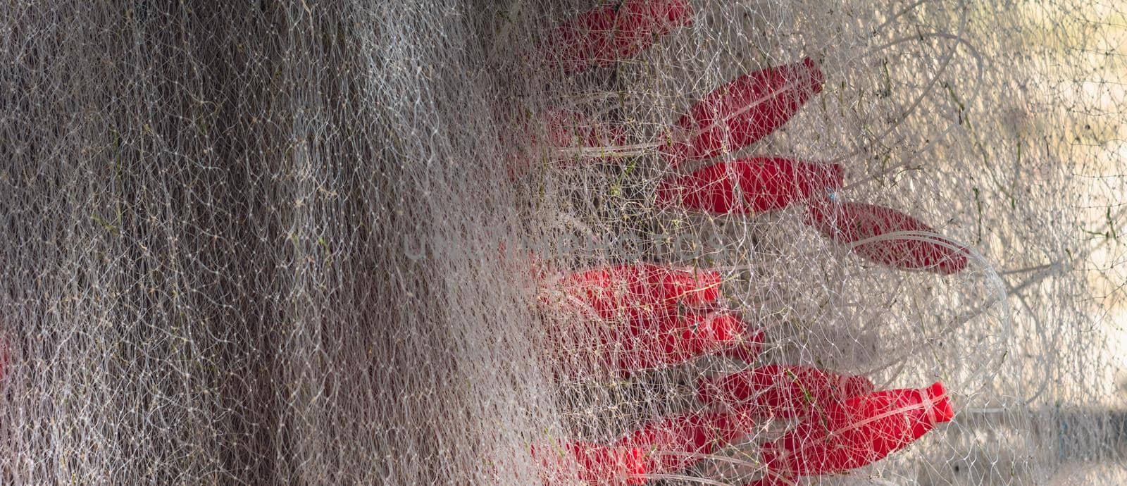 Abstract real white gray background. Macro close-up sail sea fishing line airy mesh texture, red bobber. Looks like veil fabric or Lace tulle. Modern interior decoration. Creative design. Nets maze.