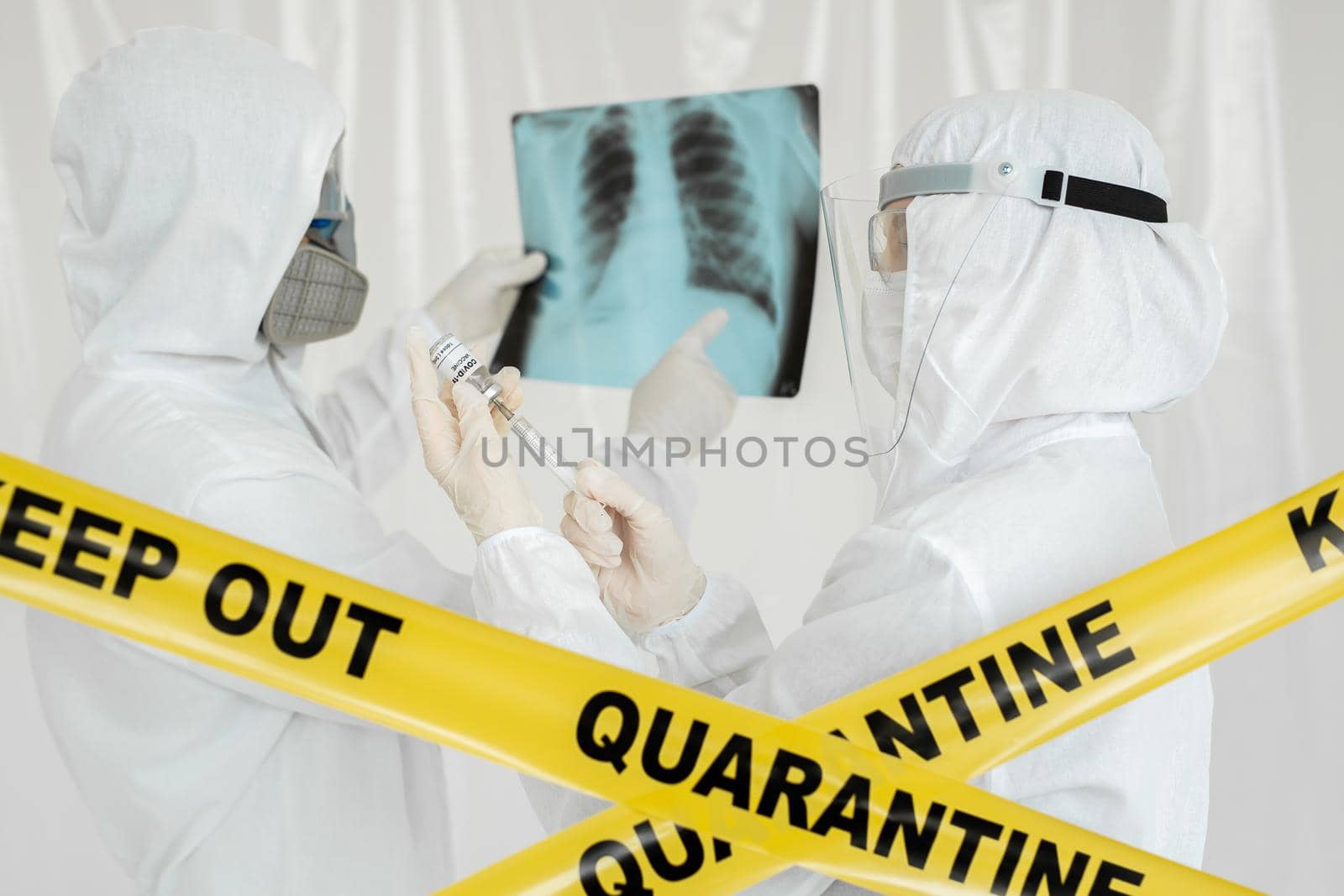 Nurse holds Coronavirus COVID-19 vaccine vial, close-up view. Doctor man with X-ray of lungs, fluorography, roentgen isolated on white background. by StudioPeace