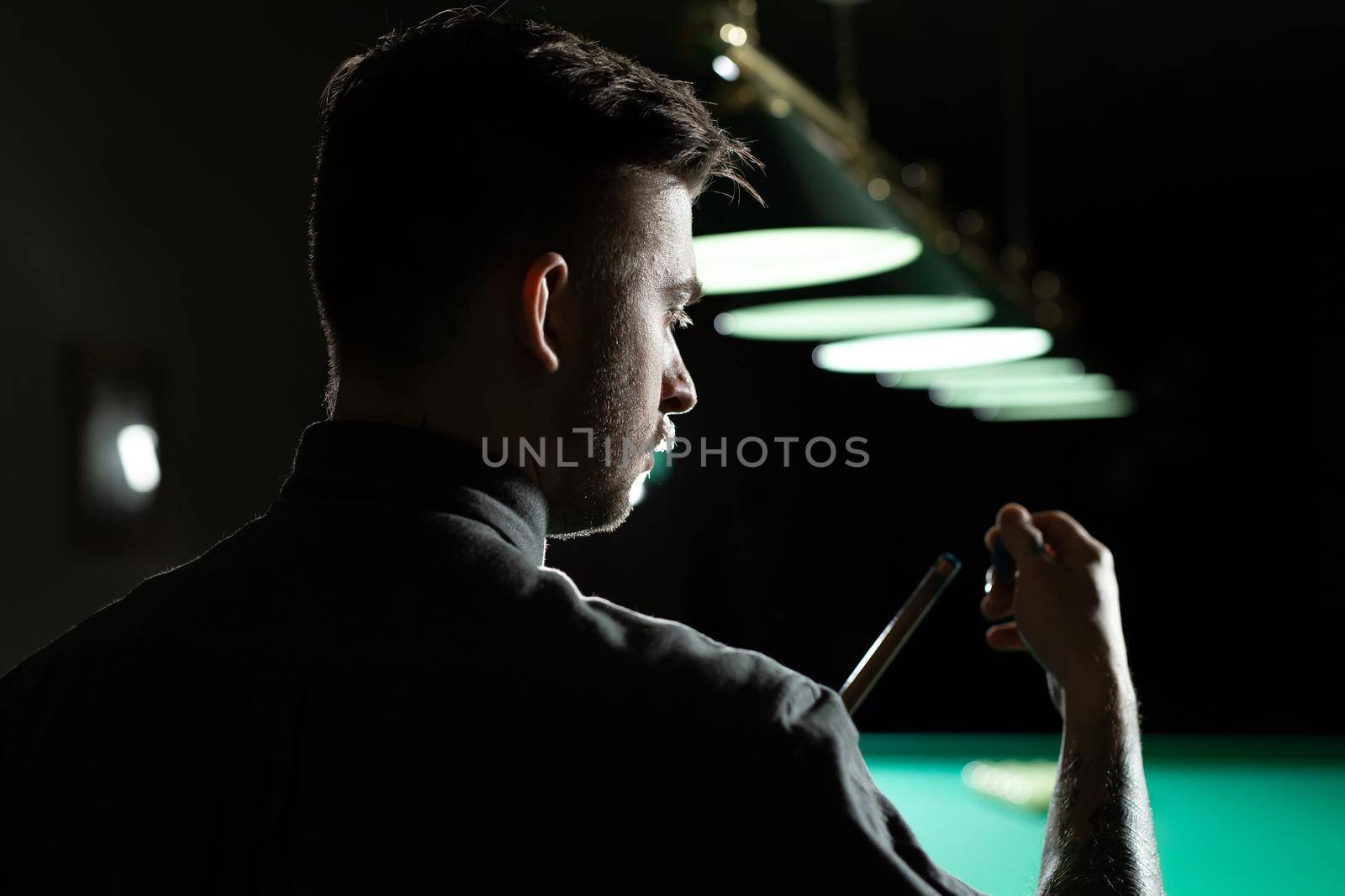 Close up of a unrecognizable man chalking pool cue
