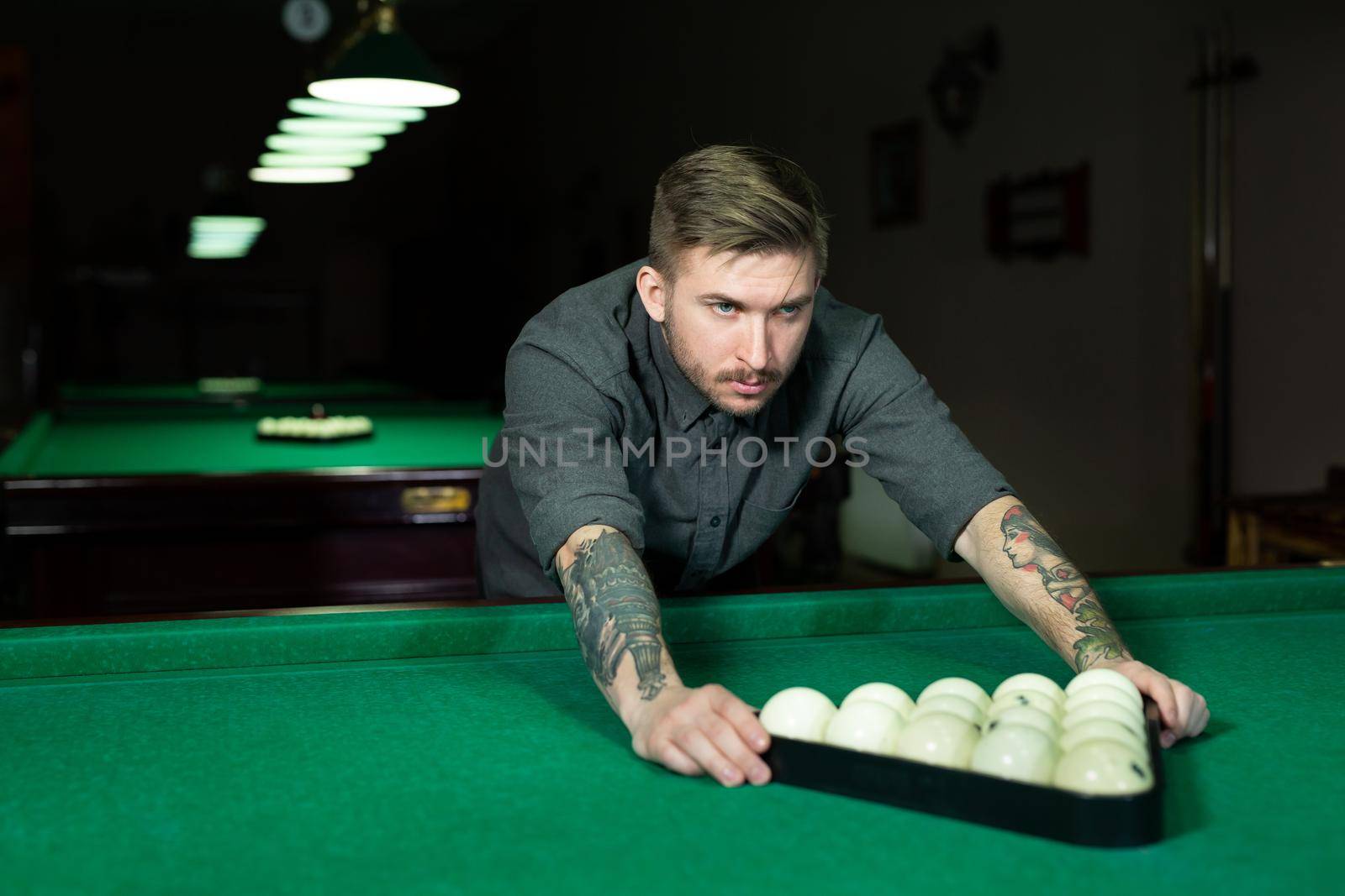 Portrait of a young man playing snooker