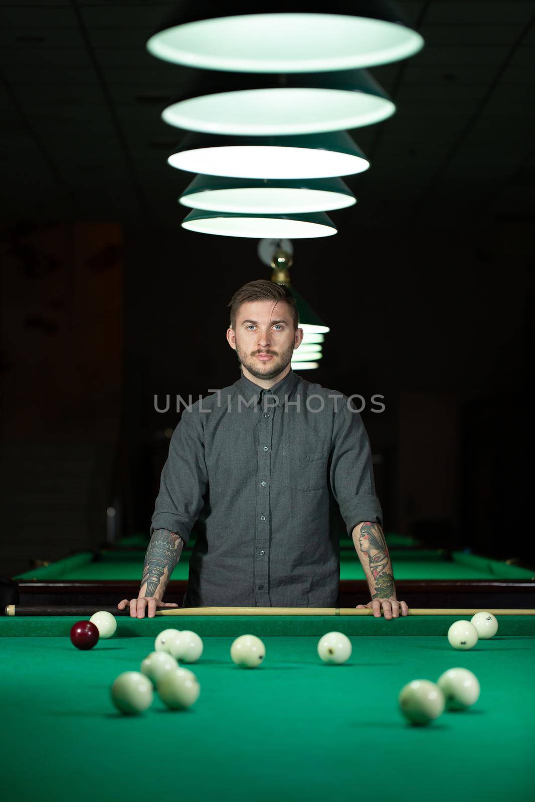 Playing billiard - Close-up shot of a man playing billiard. by StudioPeace