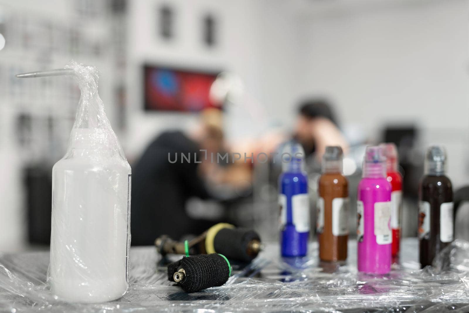 Many professional bottles with colored ink for tattoos.