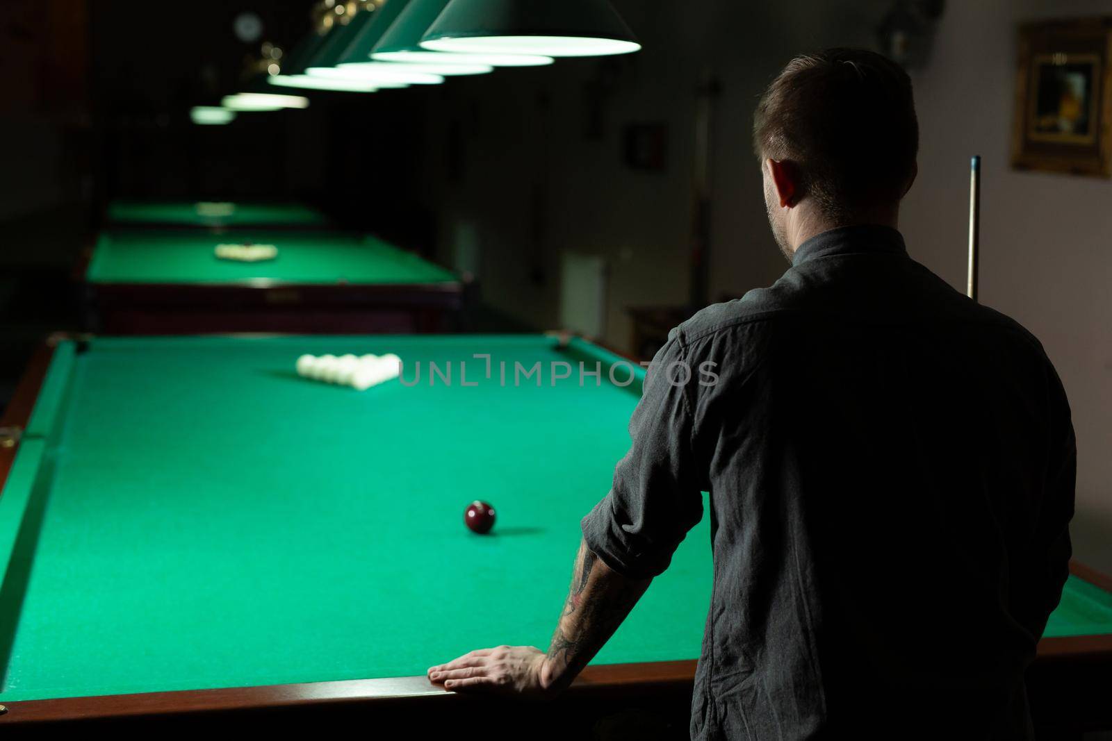 A man plays Billiards. The view from the back. by StudioPeace