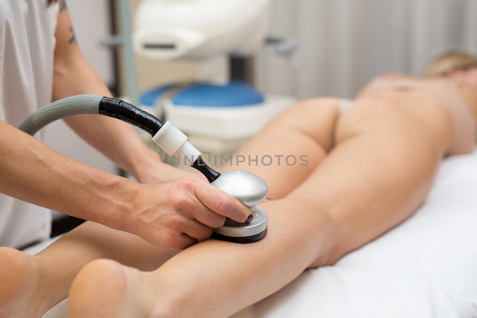Close-up process of vacuum apparatus massage of the body in the beauty salon. Rf skin tightening. Vacuum massage. Hardware cosmetology