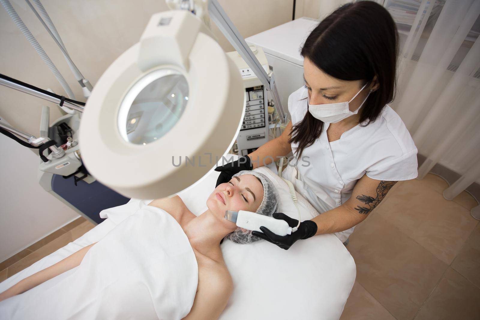 Skin Care. Close-up Of Beautiful Woman Receiving Ultrasound Cavitation Facial Peeling. Ultrasonic Skin Cleansing Procedure. Beauty Treatment. Cosmetology. Beauty Spa Salon.