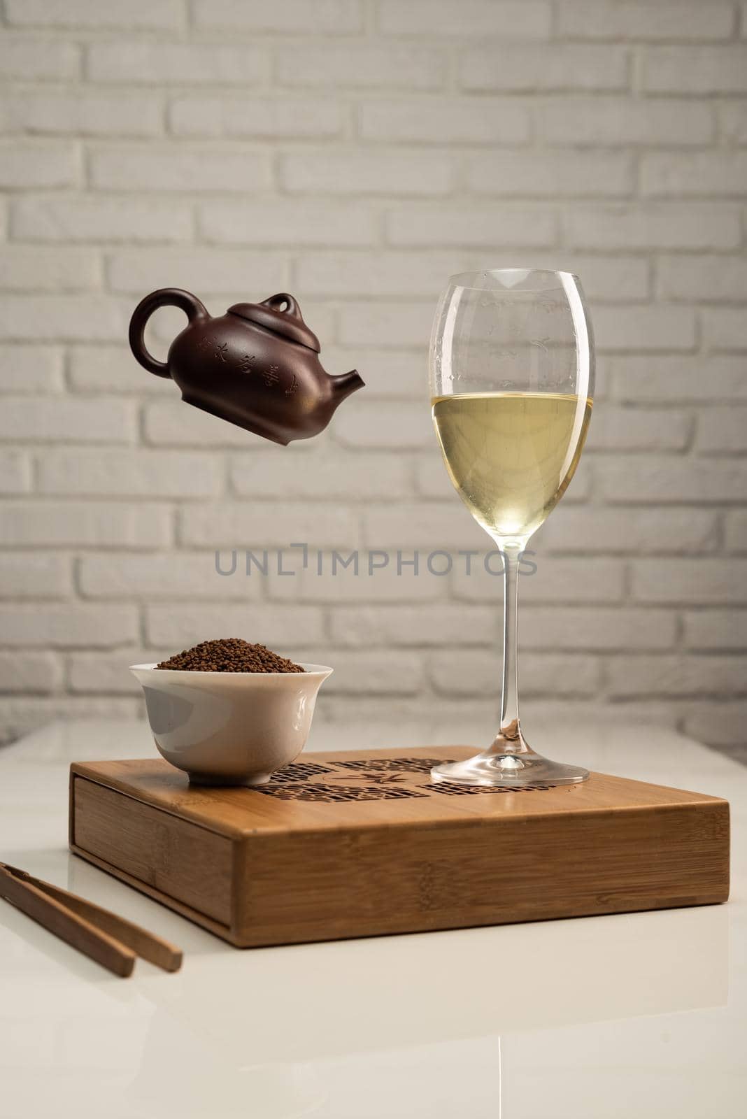 table with appliances and a wine glass in which tea is brewed