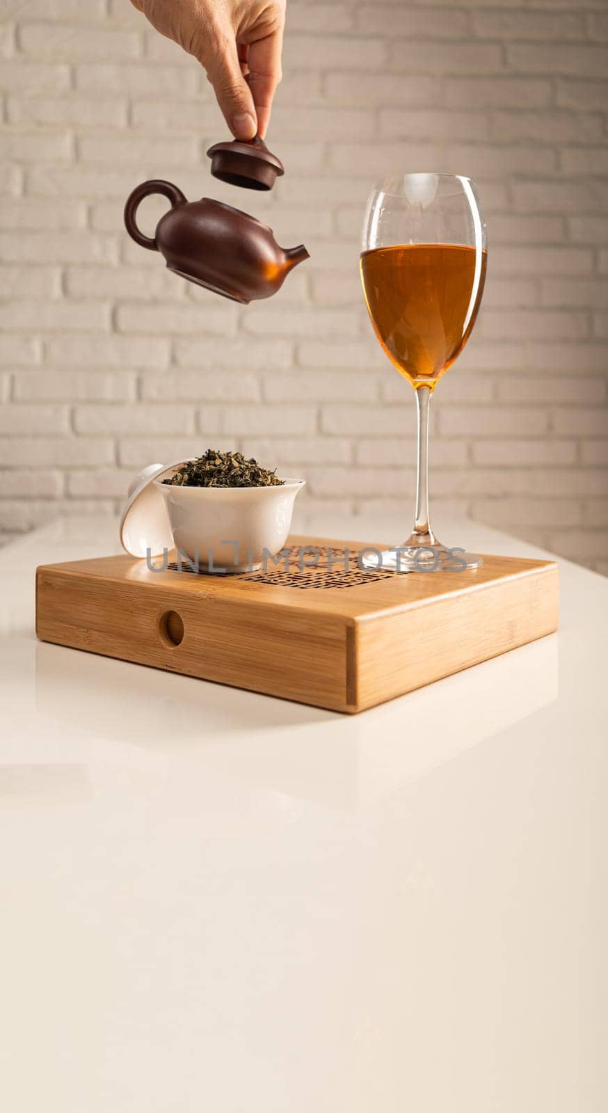 tea table with appliances and wine glasses, in which large-leaf tea is brewed