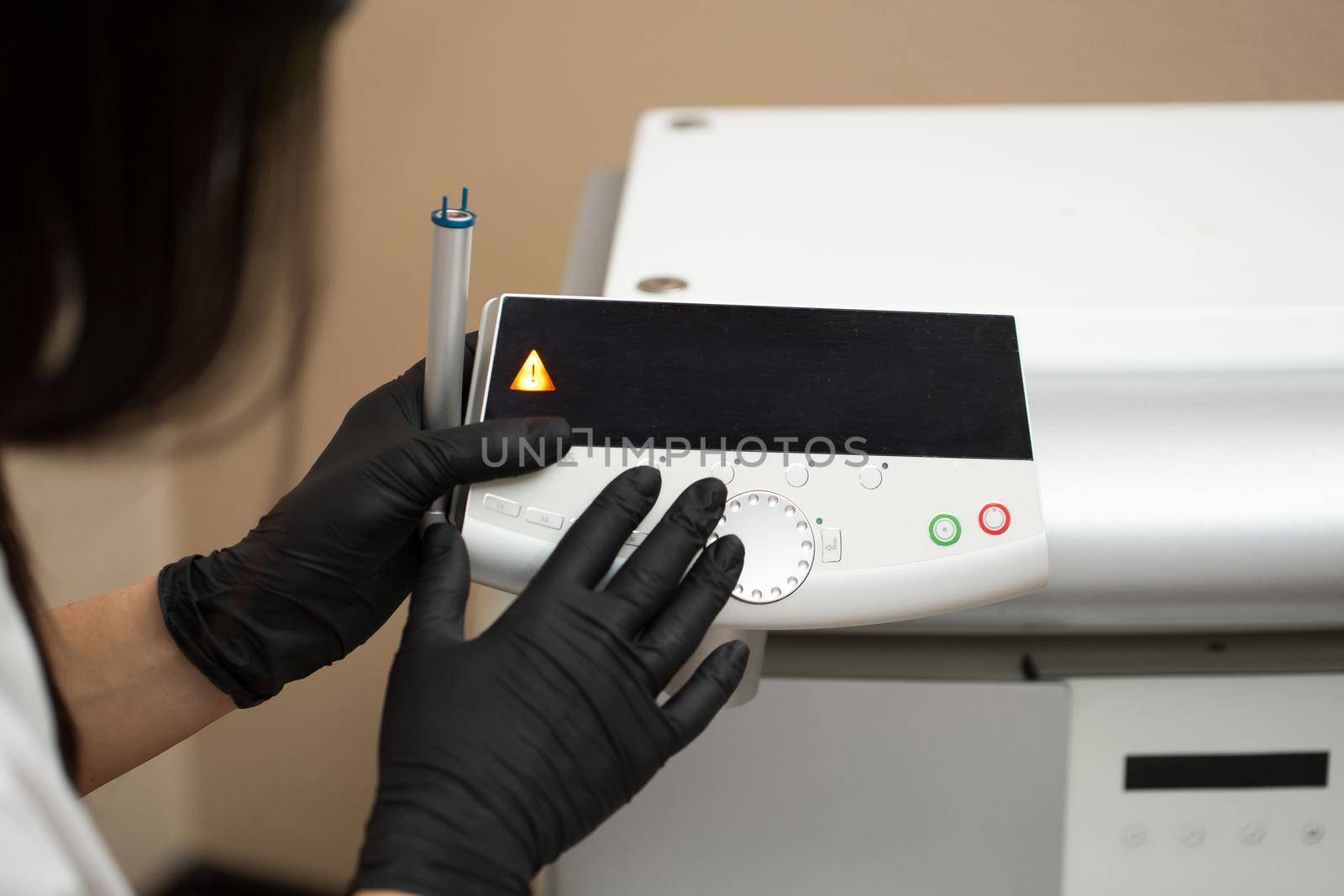 Therapist beautician makes a laser treatment to young woman's face at beauty SPA clinic. Close-up process of laser removal of blood vessels from the skin. by StudioPeace