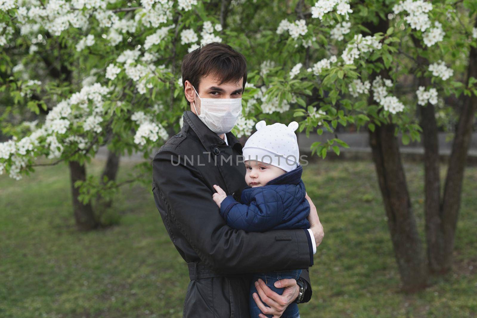 Child and man in medical protective mask on the street. Epidemic of virus covid