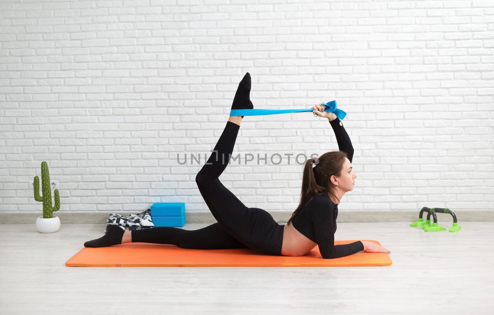 girl conducts a home workout stretching to strengthen her back