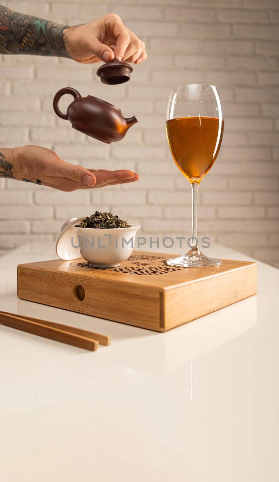 tea table with appliances and wine glasses, in which large-leaf tea is brewed by Rotozey