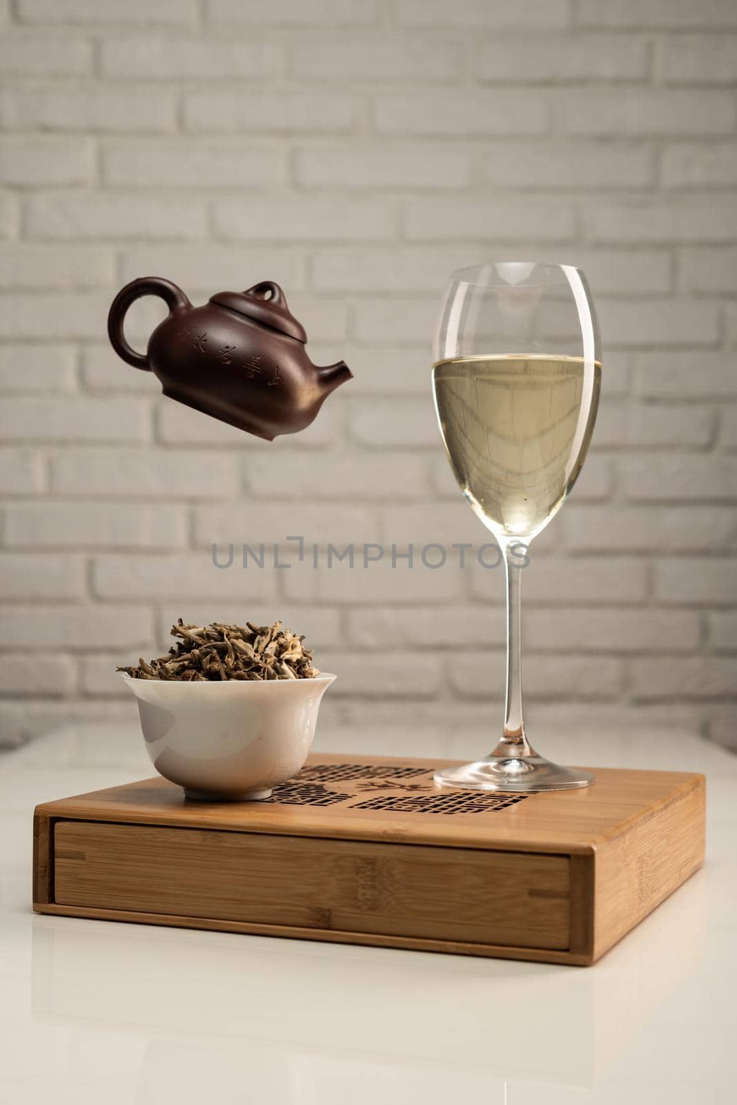 tea table with appliances and a wine glass in which tea is brewed by Rotozey