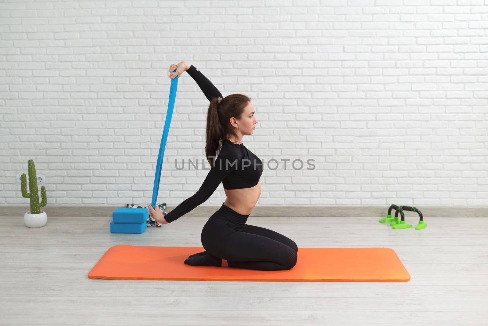 girl conducts a home workout stretching to strengthen her back