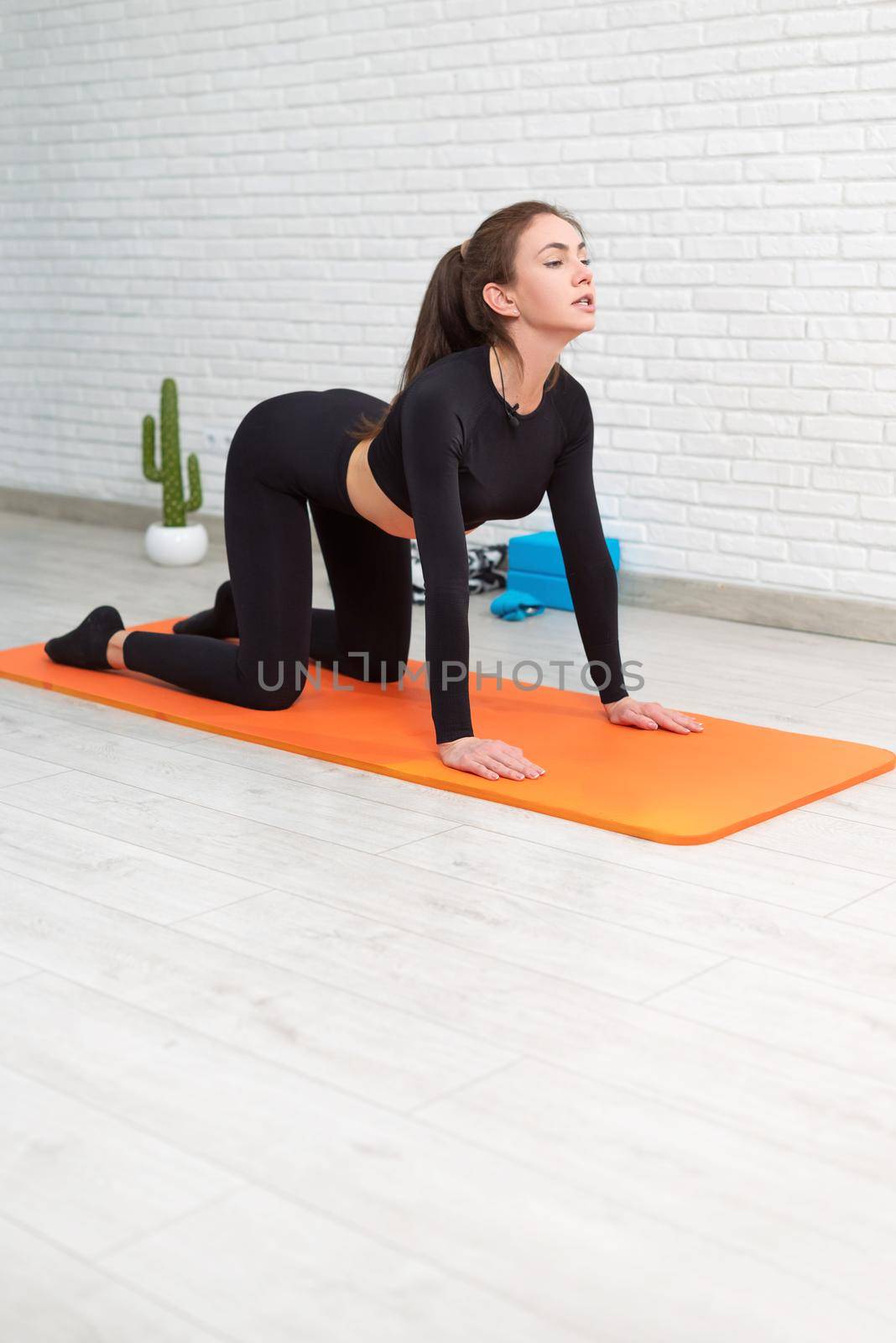 girl conducts a home workout stretching to strengthen her back