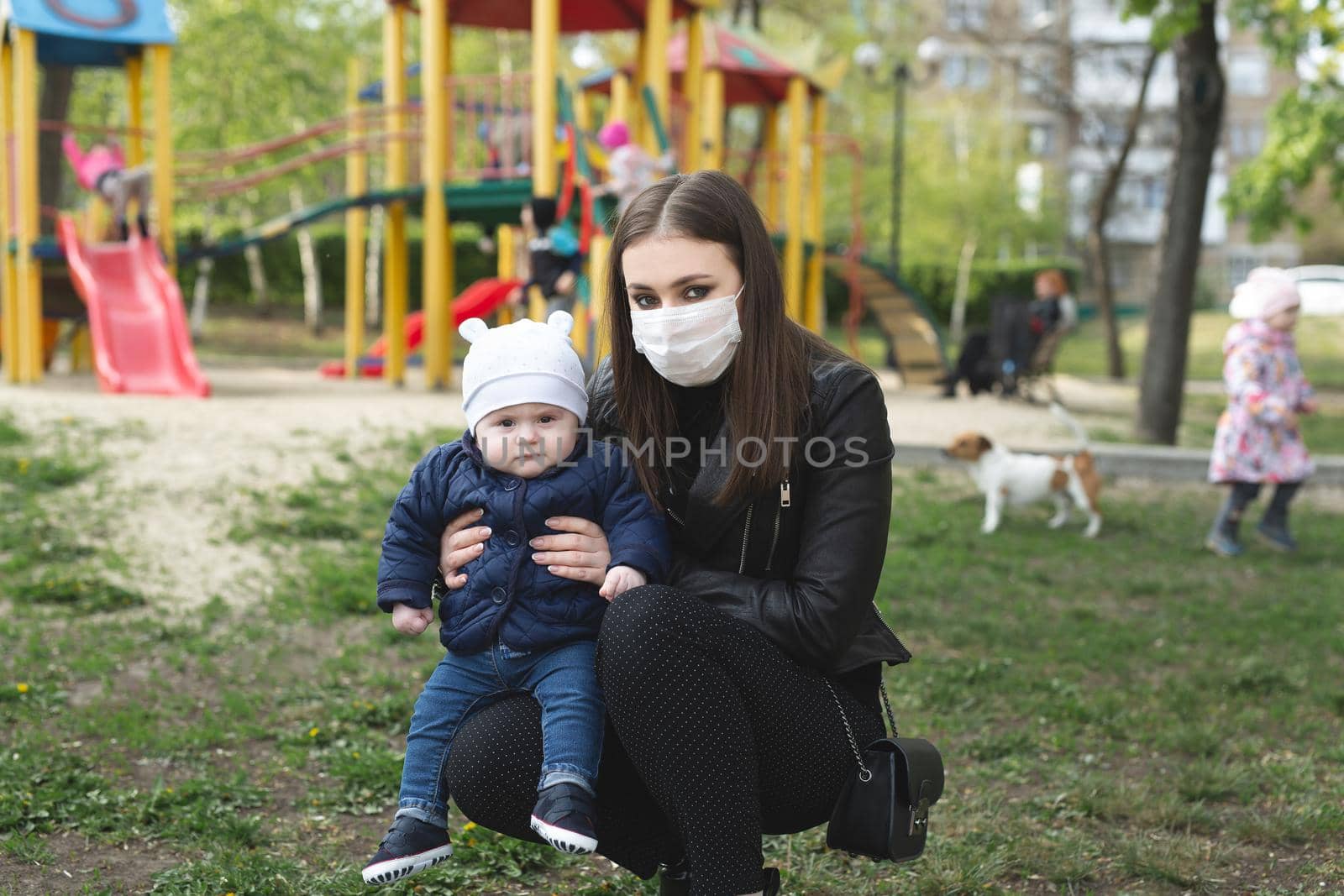 Portrait of a woman and her son in a protective mask against the crown virus or an outbreak of the covid-19 and pm 2.5 virus in the city. by StudioPeace