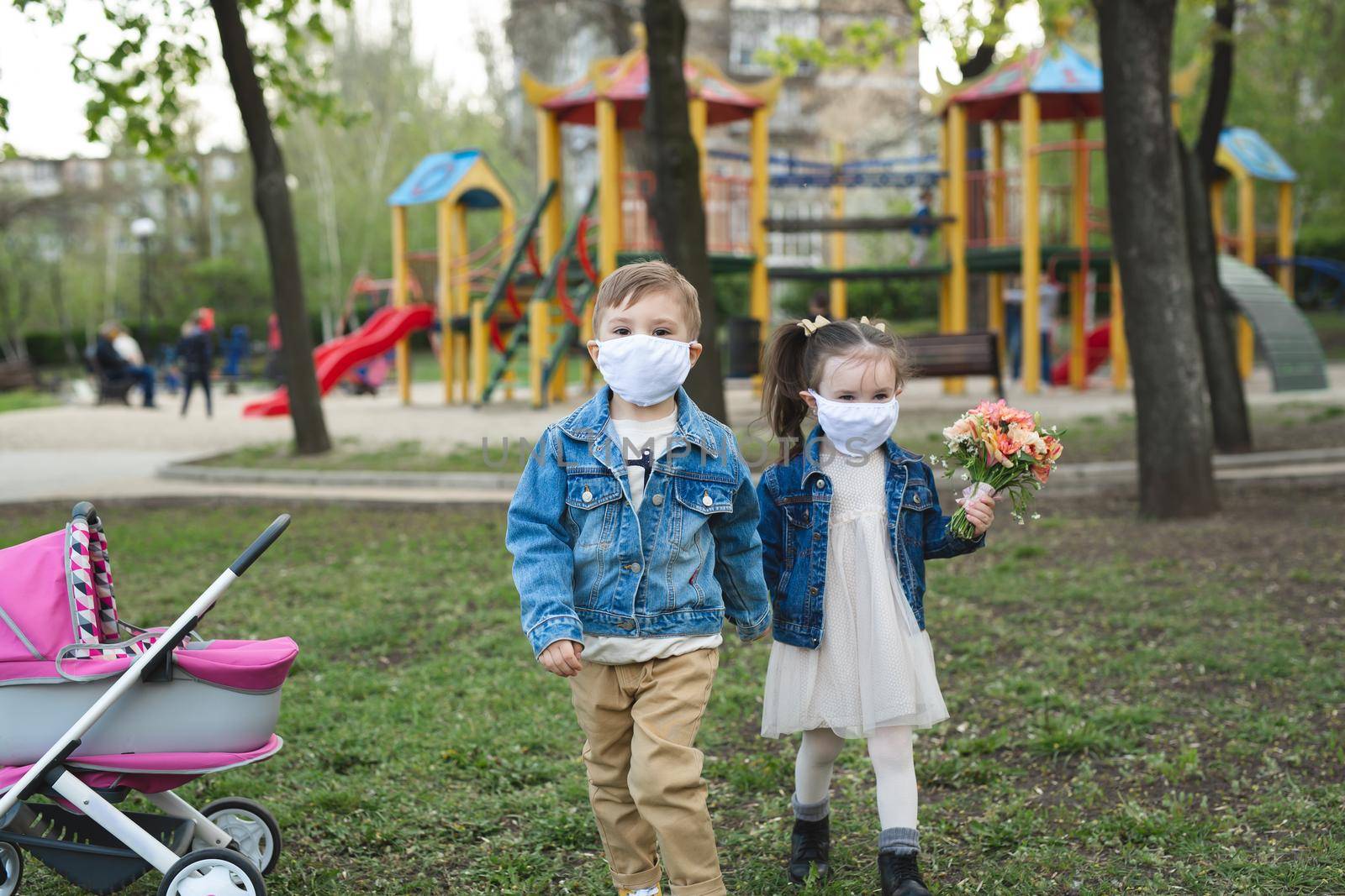 Child boy and girl walking outdoors with face mask protection. Coronavirus, covid-19