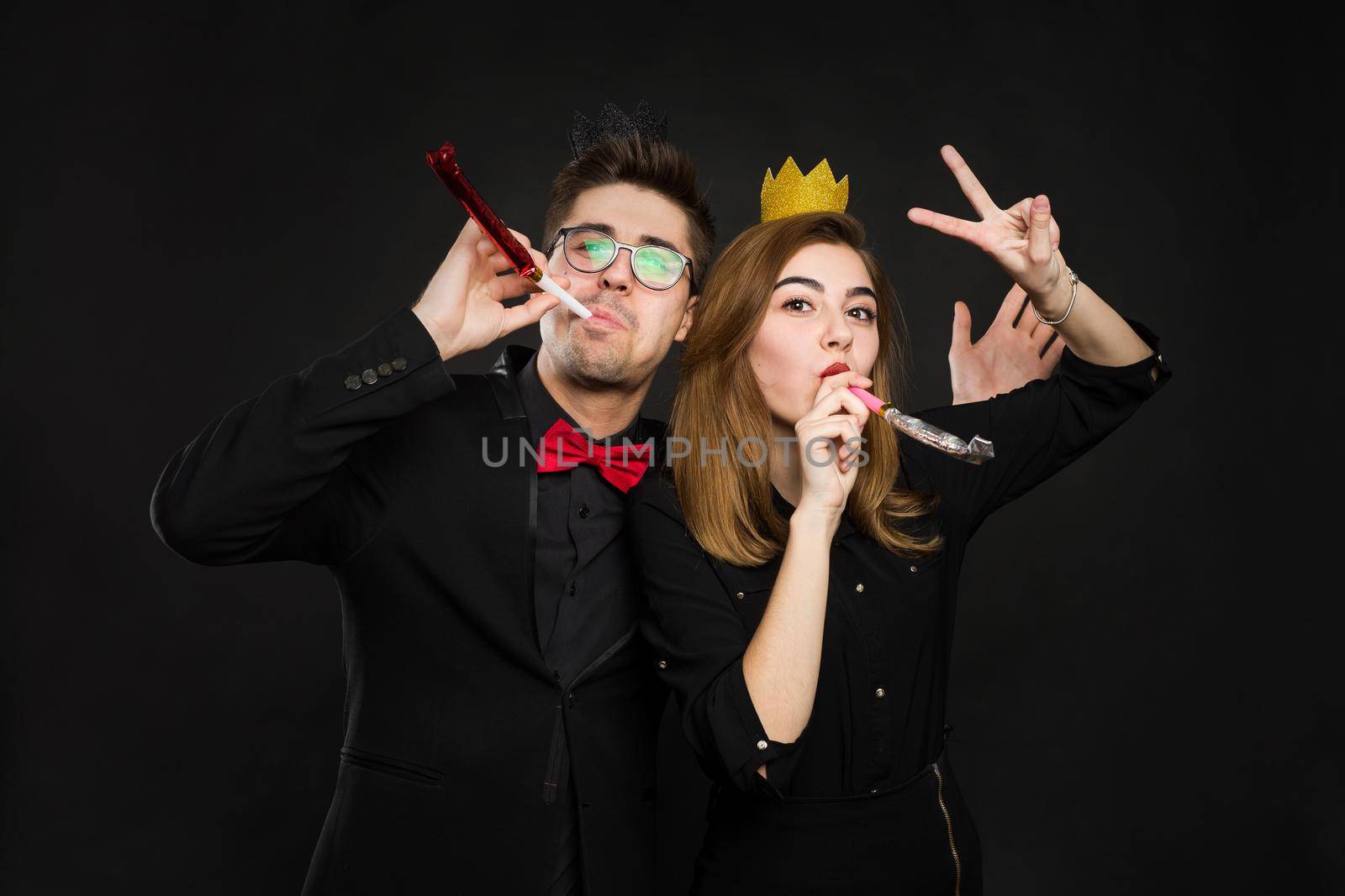 Happy couple celebrating their birthday on a brown background