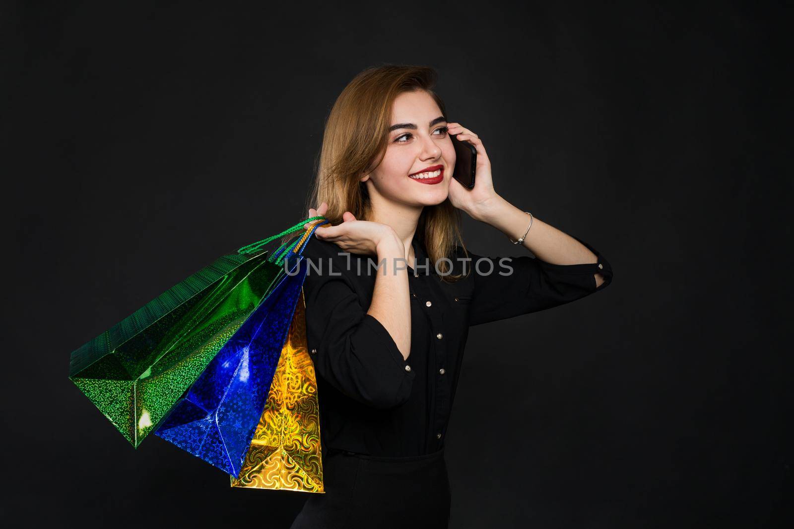 young woman with packages, shopping, discounts on a brown background. by StudioPeace