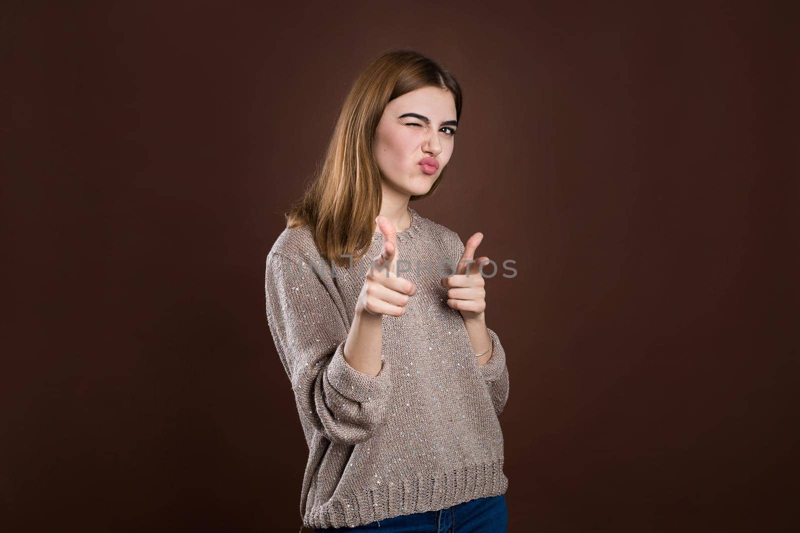 Portrait of a cool girl pointing finger at you camera showing hand gesture this is you. by StudioPeace