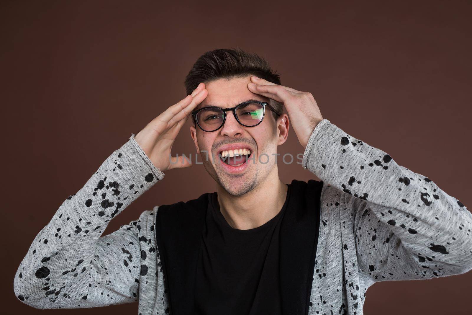 man screaming mouth open, hold head hand, isolated background, concept face emotion. by StudioPeace