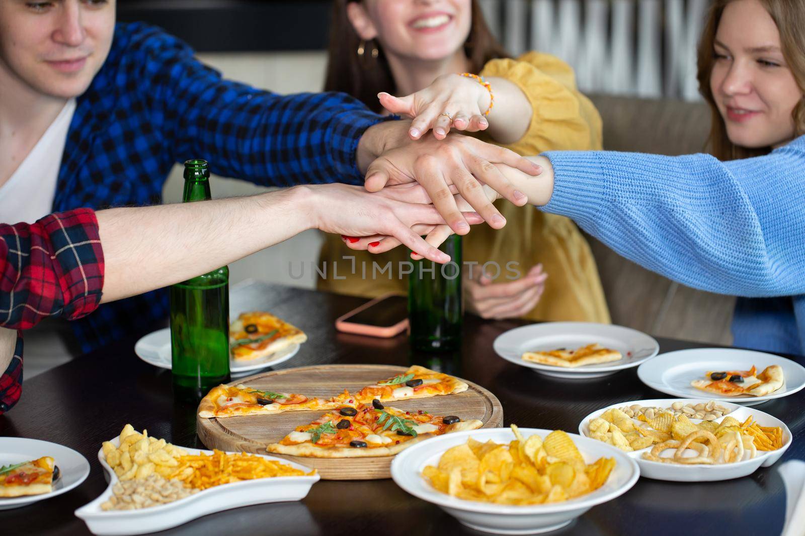 Friends play games in the pub and drink beer. by StudioPeace