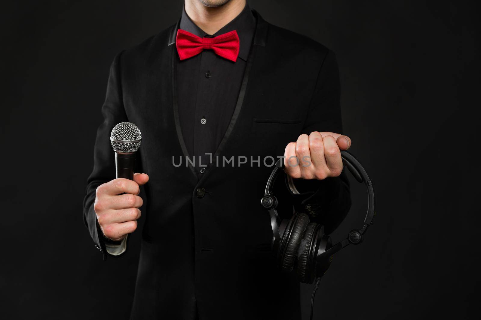DJ with headphones and microphone on a black background