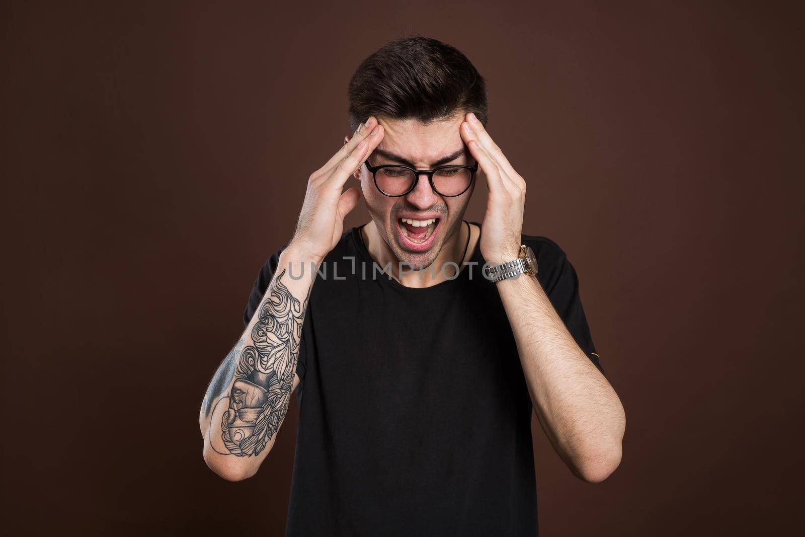 man screaming mouth open, hold head hand, isolated background, concept face emotion. by StudioPeace