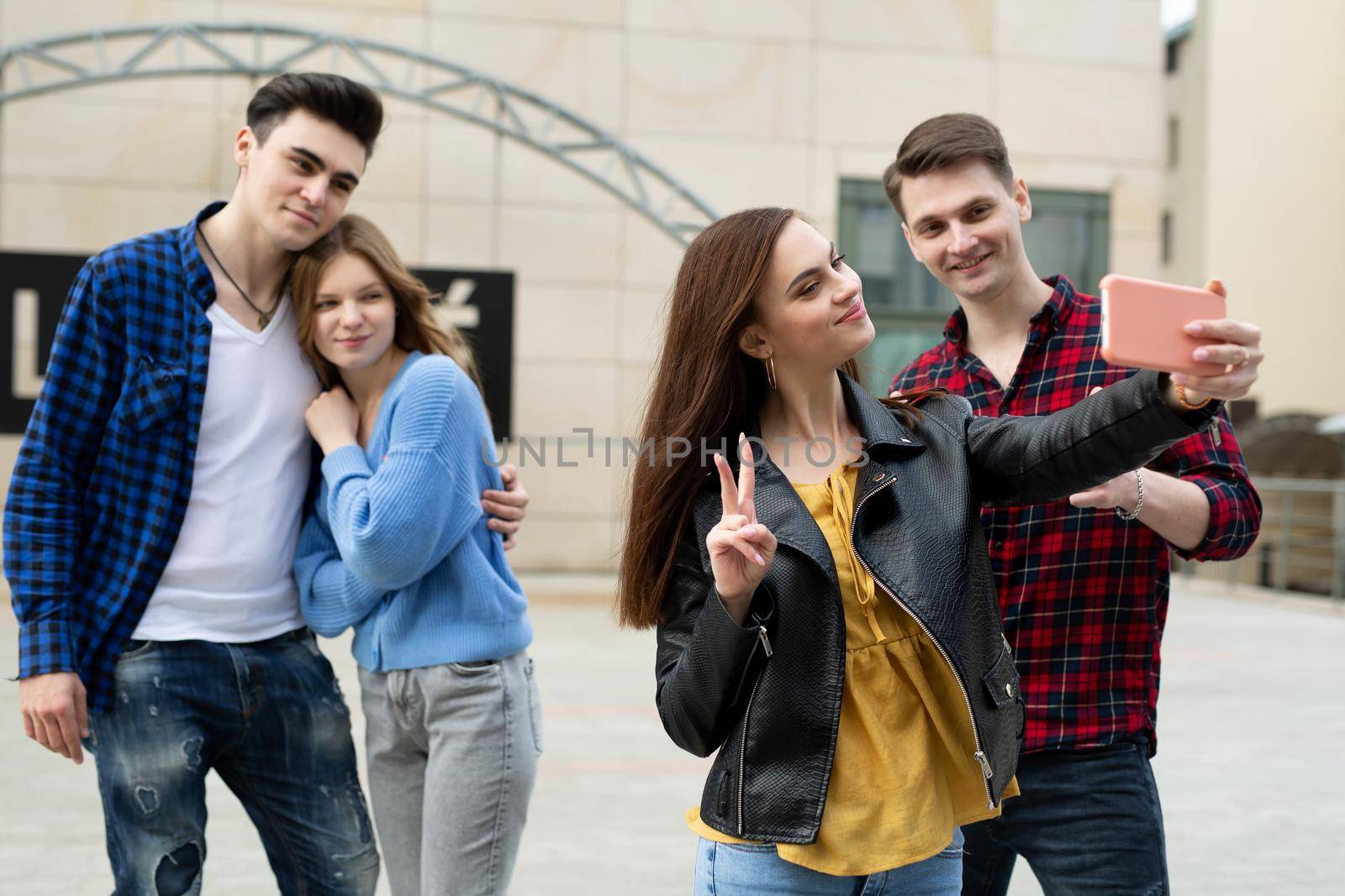 Group of friends taking picture of themselves with smartphone