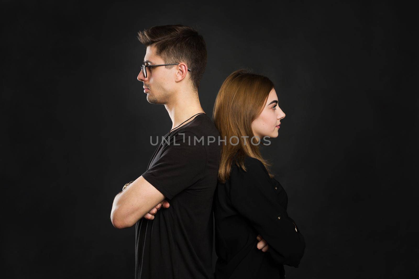 Couple back to back not talking after an argument on black screen