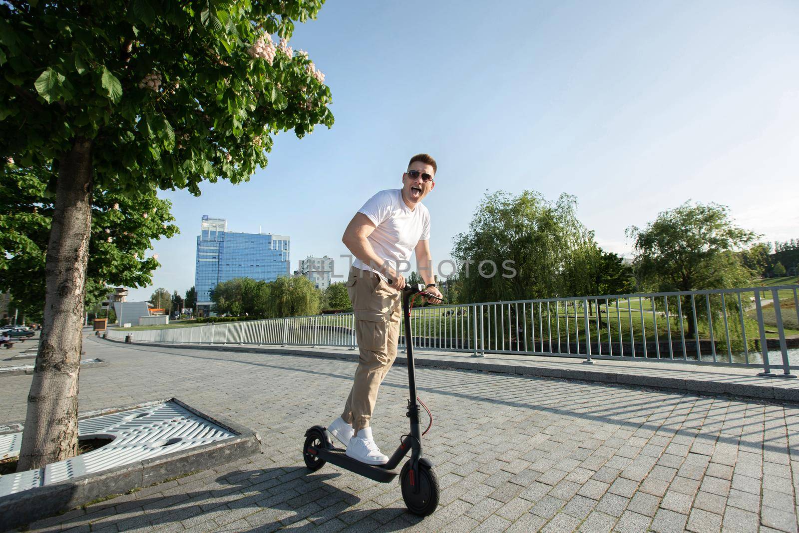 Man rides an electric scooter around the city. by StudioPeace