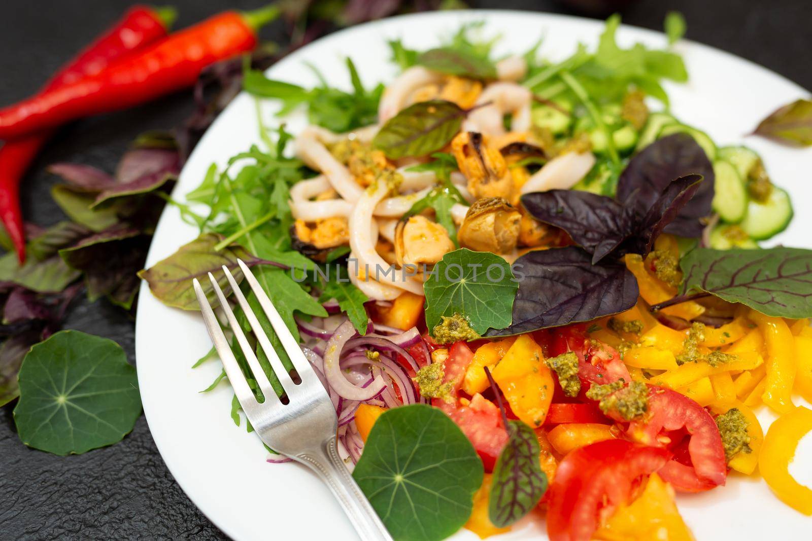 Salad of fresh vegetables, seafood, herbs and microgreen. Proper nutrition by StudioPeace