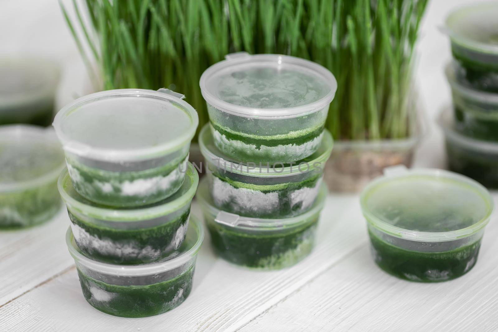 Frosted jars with wetgrass on the background of wheat germ.