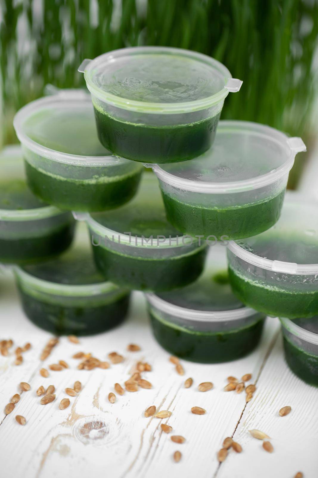 Frosted jars with wetgrass on the background of wheat germ.