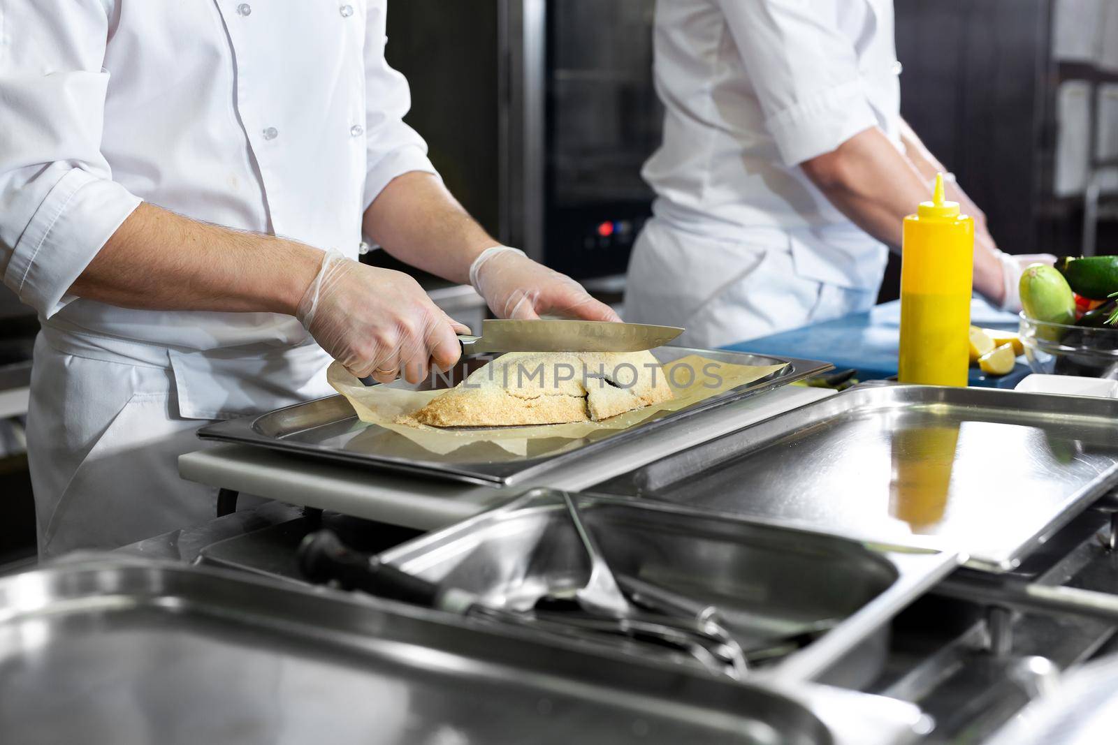 Chefs prepare delicious dishes in the kitchen by StudioPeace