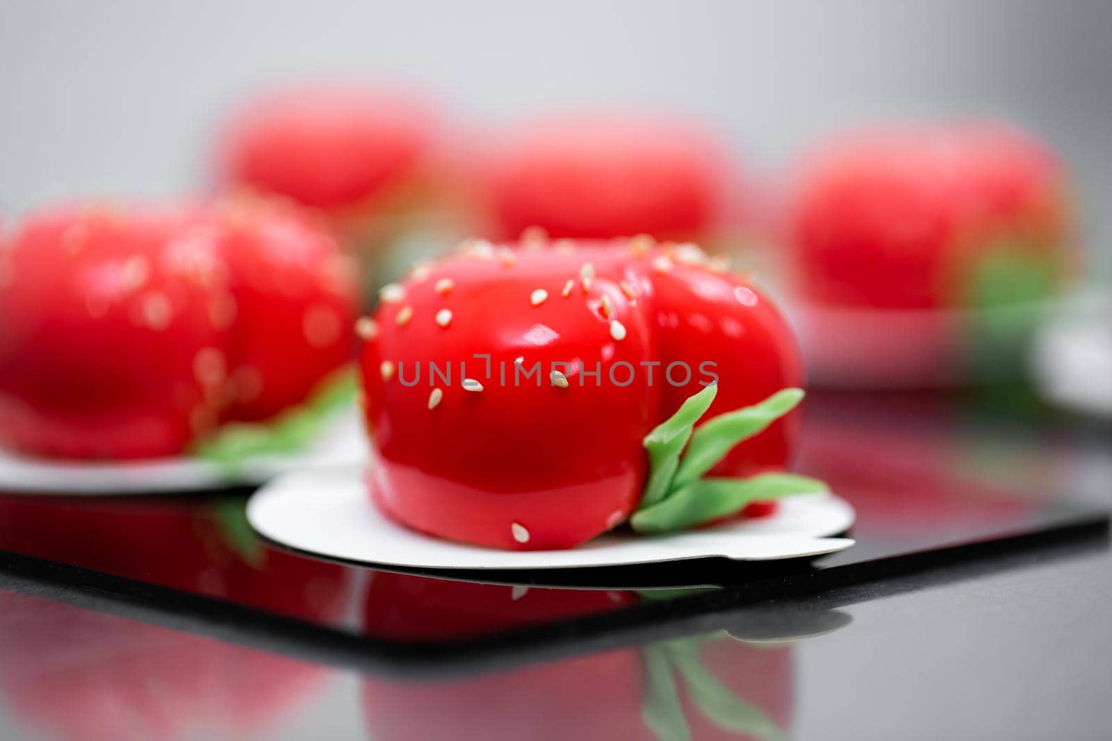 Strawberry mousse cake is on a beautiful black plate. by StudioPeace