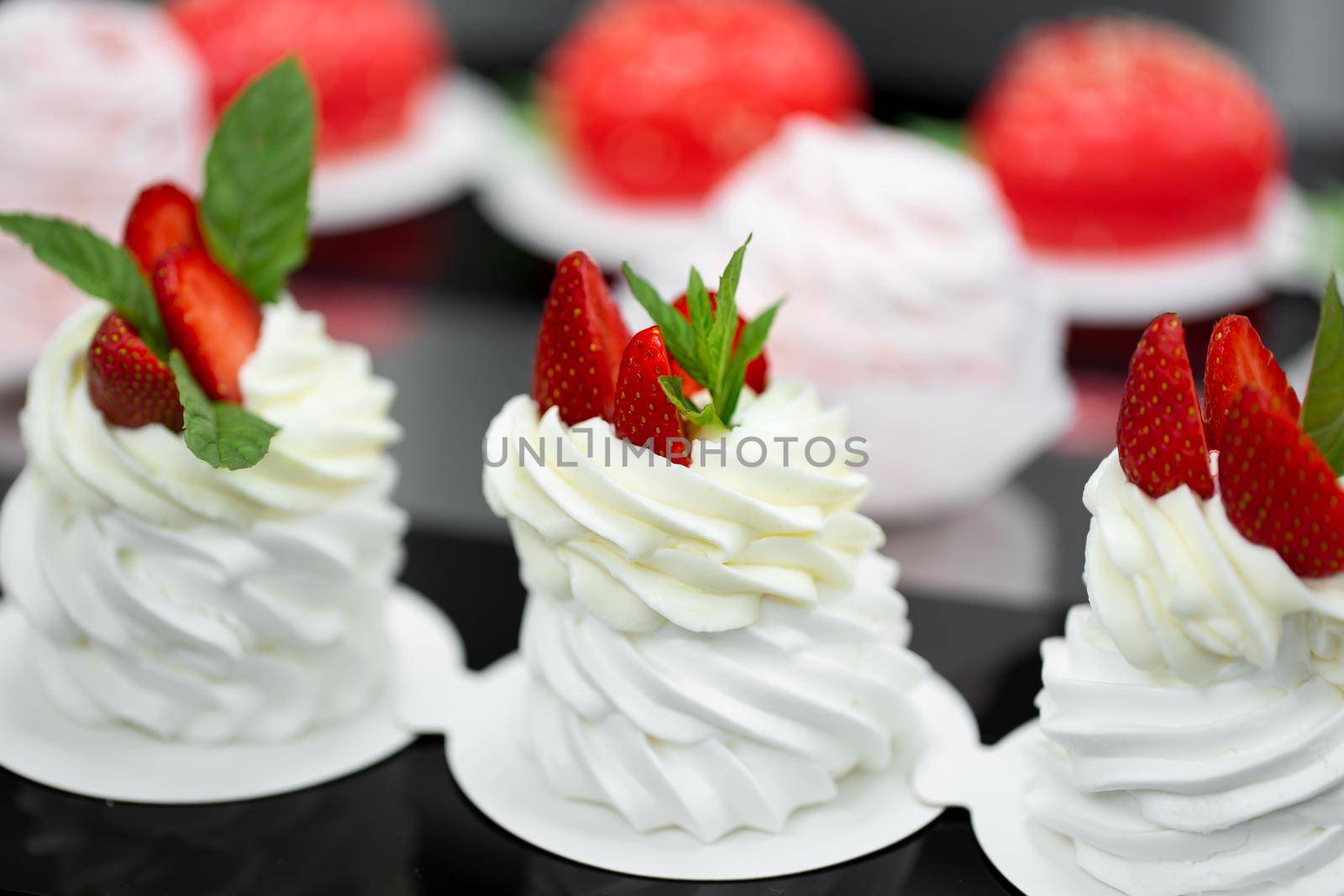 Pavlova meringue with cream and fresh strawberries.
