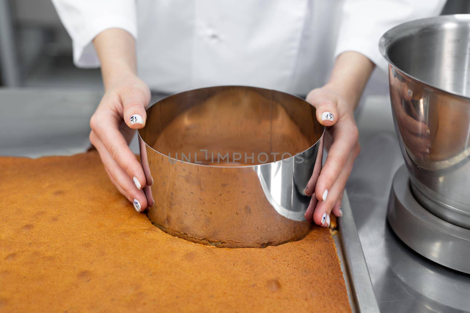 Pastry chef cuts out a cake cake from a biscuit by StudioPeace