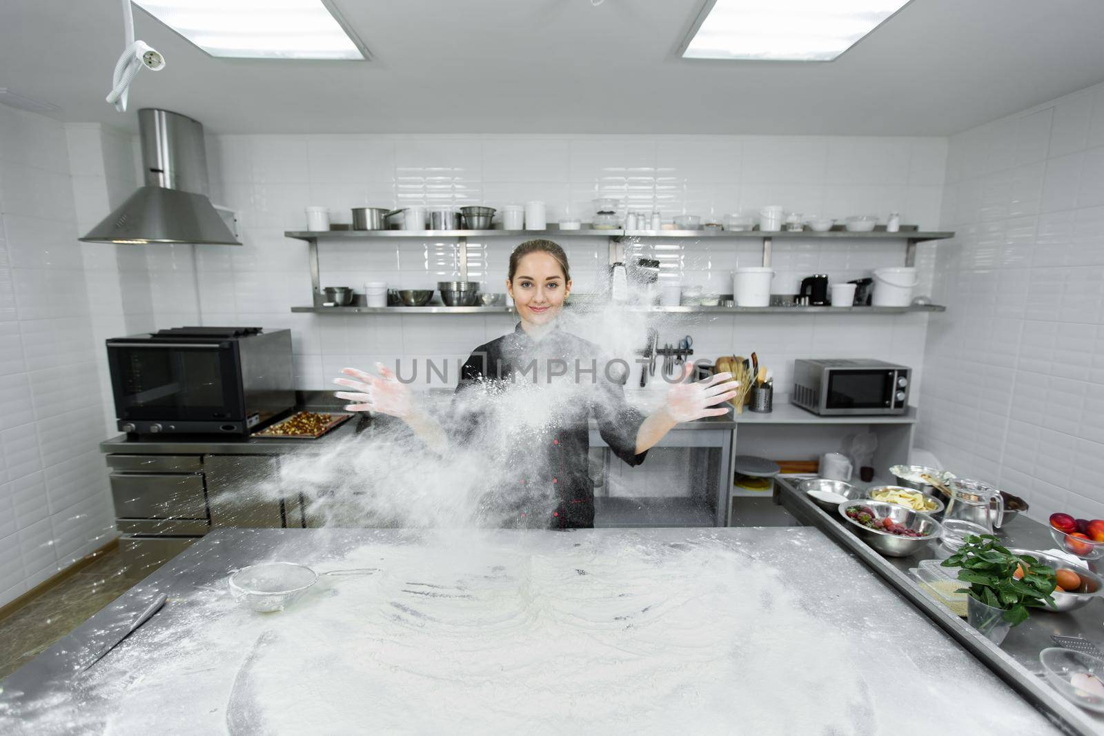 The pastry chef claps his hands and the flour is scattered all over the kitchen.